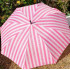 Foldable umbrella Victoria's Secret in pink stripes.
